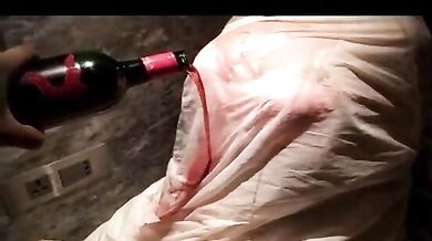 Wife seducing her husband pouring wine on her