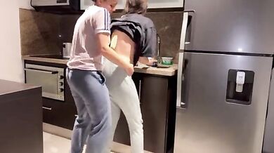 Milf fucks her lesbian daughter-in-law in the kitchen